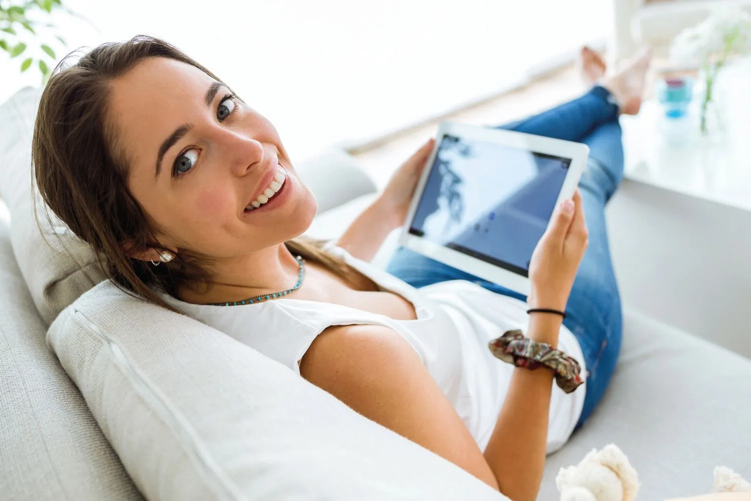 adobe 111957745_Beautiful young woman using her digital tablet at home..jpg